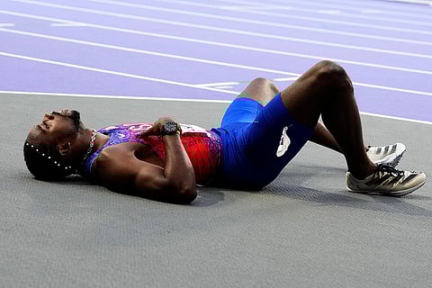 Noah Lyles, of the United States, lies on the track following the men's 200-meters final
